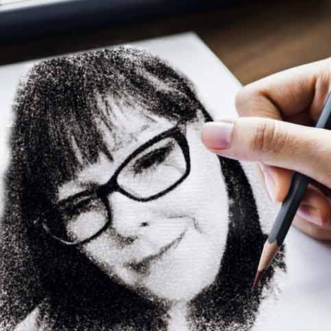 image of Eileen Gonzalez portrait being drawn by a hand with a pencil on a paper.